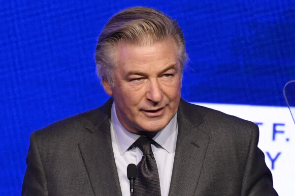 FILE - Alec Baldwin speaks at the Ripple of Hope Award Gala at New York Hilton Midtown on Thursday, Dec. 9, 2021, in New York. A lawsuit against Alec Baldwin filed by relatives of a U.S. Marine killed in Afghanistan has been resolved without the actor paying any of the $25 million sought for his chastising them on social media over the 2021 insurrection at the U.S. Capitol. (Photo by Evan Agostini/Invision/AP, File)
