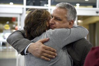 
              Jim Demetros hugs his wife Cindy as she arrives from their home in Connecticut to pick him at Philadelphia International Airport, Tuesday, April 17, 2018, after his Southwest Airlines plane landed with a damaged engine. The Southwest Airlines jet apparently blew an engine at about 30,000 feet and got hit by shrapnel that smashed a window and damaged the fuselage Tuesday, killing a passenger and injuring seven others, authorities said. (Tom Gralish/The Philadelphia Inquirer via AP)
            