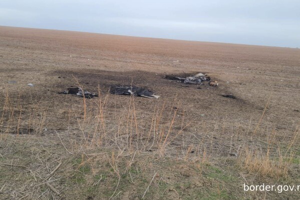 This image released by Moldova's Border Police on Sunday, Feb. 11, 2024, shows, according to the official statement, remains of a Shahed-type drone that crashed near the Etulia, Moldova, near the Moldova-Ukraine border and in the general area of the the Ukrainian Danube port of Ismail. The port was the target of a Russian air-strike in the early hours of Feb. 10. (Moldovan Border Police via AP)