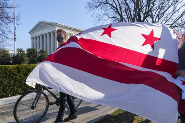 FILE - In this March 22, 2021, file photo advocates for statehood for the District of Columbia rally near the Supreme Court and Capitol prior to a House of Representatives hearing on creating a fifty-first state, in Washington. (AP Photo/J. Scott Applewhite, FIle)