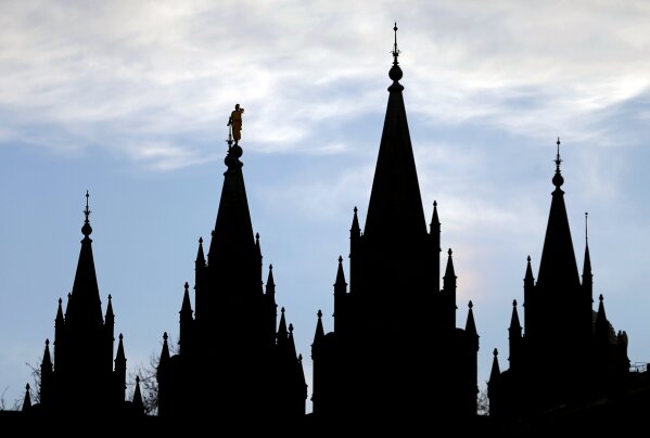 FILE - In this Jan. 3, 2018, file photo, the angel Moroni statue, silhouetted against the sky, sits atop the Salt Lake Temple at Temple Square in Salt Lake City. Utah is set to become the 19th state to enact a ban on the discredited practice of conversion therapy after state officials revised a proposal to win back the support of the influential Church of a Jesus Christ of Latter-day Saints. (AP Photo/Rick Bowmer, File)