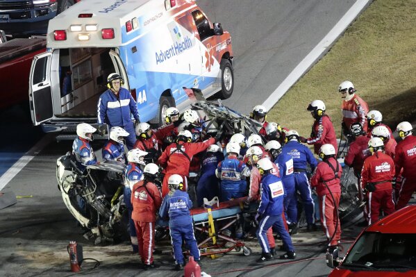 Rescue workers remove Ryan Newman from his car after he was involved in a wreck on the last lap of the NASCAR Daytona 500 auto race at Daytona International Speedway, Monday, Feb. 17, 2020, in Daytona Beach, Fla. (AP Photo/David Graham)