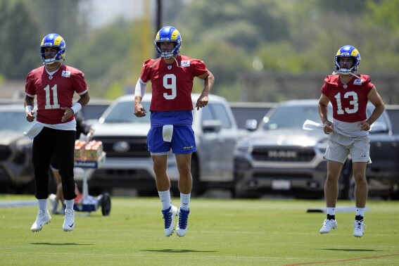 Los Angeles Rams quarterback Jimmy Garoppolo, left, Matthew Stafford, center, and Stetson Bennett warm up during the NFL football team's organized team activities Tuesday, May 28, 2024, in Thousand Oaks, Calif. (AP Photo/Marcio Jose Sanchez)