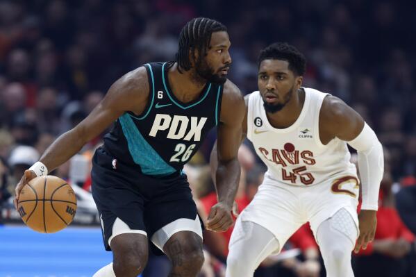 Portland Trail Blazers forward Justise Winslow (26) plays against Cleveland Cavaliers guard Donovan Mitchell (45) during the first half of an NBA basketball game, Wednesday, Nov. 23, 2022, in Cleveland. (AP Photo/Ron Schwane)