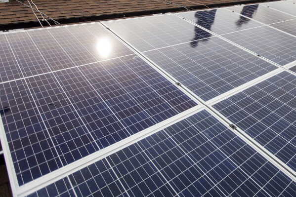 FILE - In a Friday, Aug. 3, 2018 photo, solar panels line the roof of Harmony House as part of a project by Solar Holler in Huntington, W.V. An entire county school system in coal-producing West Virginia is going solar, representing what developer Solar Holler and U.S. Sen. Joe Manchin's office called Wednesday, Nov. 29, 2023, the largest-ever single demonstration of sun-powered renewable electricity in Appalachian public schools. (Sholten Singer/The Herald-Dispatch via AP, File)