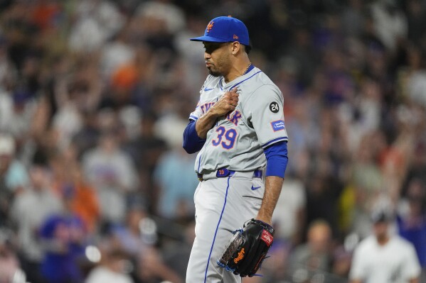 New York Mets pitcher Edwin Díaz reacts after striking out Colorado Rockies' Charlie Blackmon to end a baseball game Wednesday, Aug. 7, 2024, in Denver. (AP Photo/David Zalubowski)