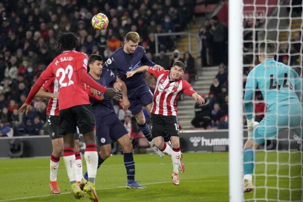 Manchester City's Aymeric Laporte is pulled down by Southampton's Romain Perraud, center right, when trying to head the ball during the English Premier League soccer match between Southampton and Manchester City at St Mary's stadium in Southampton, England, Saturday, Jan. 22, 2022. (AP Photo/Kirsty Wigglesworth)