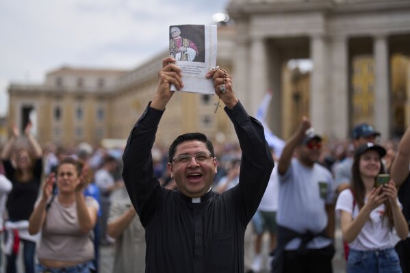 A priest celebrates as Pope Leo XIV appears at the central balcony of St. Peter's Basilica for his first Sunday blessing after his election, in St. Peter's Square at the Vatican, Sunday, May 11, 2025.(AP Photo/Bernat Armangue)