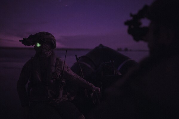 Ukraine Special Operations Forces soldiers navigate the Dnipro River using night vision goggles, or NVG, during a night mission in Kherson region, Ukraine, Saturday, June 10, 2023. Ukrainian special forces officers spent six months on their mission to establish a bridgehead across the Dnipro River in southern Ukraine after an explosion destroyed the Kakhovka Dam upstream. (AP Photo/Felipe Dana)