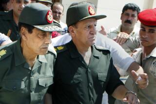 FILE - In this Sept. 16, 2011, file photo, Egypt's then military ruler field marshal Hussein Tantawi, left, and Sami Annan, then Egyptian chief of staff of the armed forces, are surrounded by military policemen as they attend the funeral of Khaled Abdel Nasser, the son of Egypt's late president Gamal Abdel Nasser, in Cairo, Egypt. Tantawi, the Egyptian general who ruled the country following the Arab Spring uprising that removed longtime autocrat Hosni Mubarak, died on Tuesday, Sept. 21, 2021, Egypt's presidency said. He was 85. (AP Photo/Amr Nabil, File)