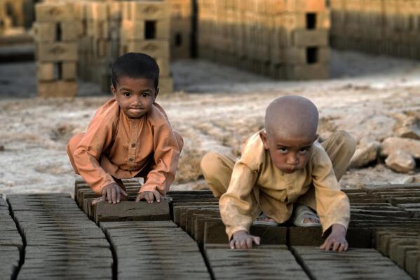 Afghan children work in a brick factory on the outskirts of Kabul, Afghanistan, Tuesday, July 26, 2022. Aid agencies say the number of children working in Afghanistan is growing ever since the economy collapsed following the Taliban takeover more than a year ago. (AP Photo/Ebrahim Noroozi)