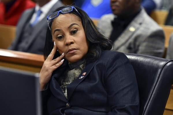 FILE - Fulton County District Attorney Fani Willis appears during a hearing regarding defendant Harrison Floyd, a leader in the organization Black Voices for Trump, as part of the Georgia election indictments, Nov. 21, 2023, in Atlanta. A Georgia judge who is deciding whether to toss Fulton County District Attorney Fani Willis off of her election interference case against former President Donald Trump has set a hearing for Thursday that is expected to focus on details of Willis' personal relationship with a special prosecutor she hired. (Dennis Byron/Hip Hop Enquirer via AP, File)