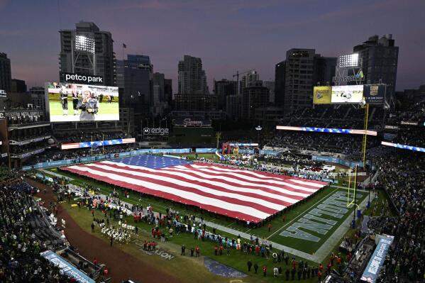 A U.S flag is rolled out onto the field before the Holiday Bowl NCAA college football game between North Carolina and Oregon Wednesday, Dec. 28, 2022, in San Diego. (AP Photo/Denis Poroy)