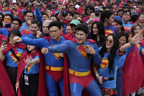 Superman fans dressed in costumes pose during an event as part of the first stop of the Superman World Tour in Pasig city, Philippines on Thursday June 19, 2025. (AP Photo/Aaron Favila)