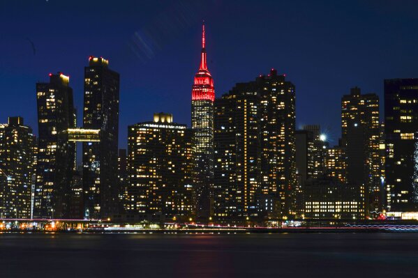 The Empire State Building is lit in “heartbeat” red as part of a national memorial to lives lost to COVID-19 Tuesday, Jan. 19, 2021, in New York. The U.S. death toll from the coronavirus has surpassed 400,000, providing a grim coda to Donald Trump's presidency. (AP Photo/Frank Franklin II)