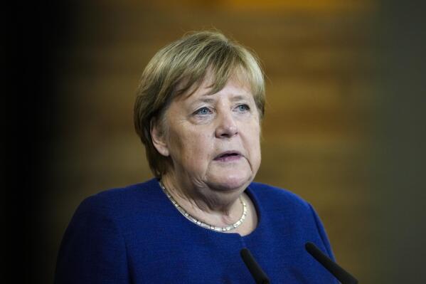FILE - At this time German Chancellor Angela Merkel talks to the media during her visit at the TUMO education center for creative technologies in Berlin, Germany, Monday, Nov. 22, 2021. Former German Chancellor Angela Merkel has defended decisions made during her time in power to buy natural gas from Russia, which was Germany's main gas supplier when she left power. (AP Photo/Markus Schreiber, Pool, File)