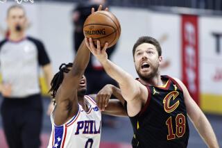 FILE - In this April 1, 2021, file photo, Cleveland Cavaliers' Matt Dellavedova (18) shoots ahead of Philadelphia 76ers' Tyrese Maxey (0) in the first half of an NBA basketball game in Cleveland. The former feisty Cavaliers guard signed a three-year contract Friday, July 9, 2021, with Melbourne United, the defending champion in Australia's National Basketball League. Dellavedova, affectionately known as “Delly” to his teammates and fans, had two stints over six seasons with Cleveland, which signed him as an undrafted free agent in 2013 (AP Photo/Ron Schwane, File)