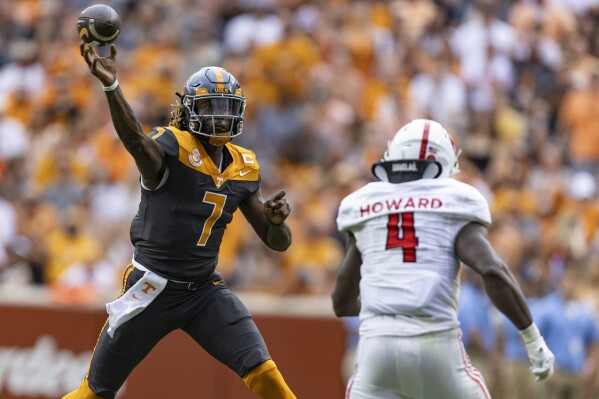 Tennessee quarterback Joe Milton III (7) throws to a receiver as he is pressured by Austin Peay linebacker Sam Howard (4) during the first half of an NCAA college football game Saturday, Sept. 9, 2023, in Knoxville, Tenn. (AP Photo/Wade Payne)
