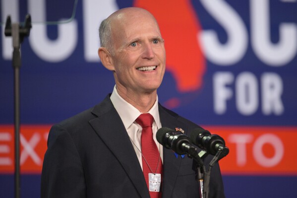 FILE - U.S. Sen. Rick Scott, R-Fla., addresses attendees at the Republican Party of Florida Freedom Summit, Nov. 4, 2023, in Kissimmee, Fla. To continue holding his seat in Florida, Scott needs to appeal to key voter groups in the state. With a new series of ads rolled out by the senator, Scott is spending multiple millions to focus on the prominent Florida Hispanic voter group as part of this goal. (AP Photo/Phelan M. Ebenhack, File)