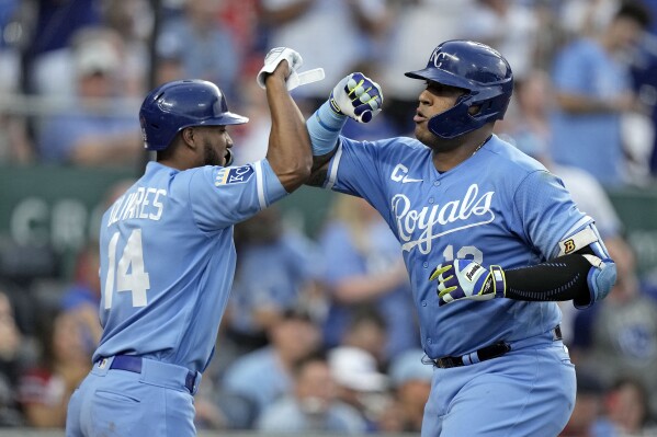 Kansas City Royals' Salvador Perez, right, celebrates with Edward Olivares (14) after hitting a solo home run during the second inning of a baseball game St. Louis Cardinals Friday, Aug. 11, 2023, in Kansas City, Mo. (AP Photo/Charlie Riedel)