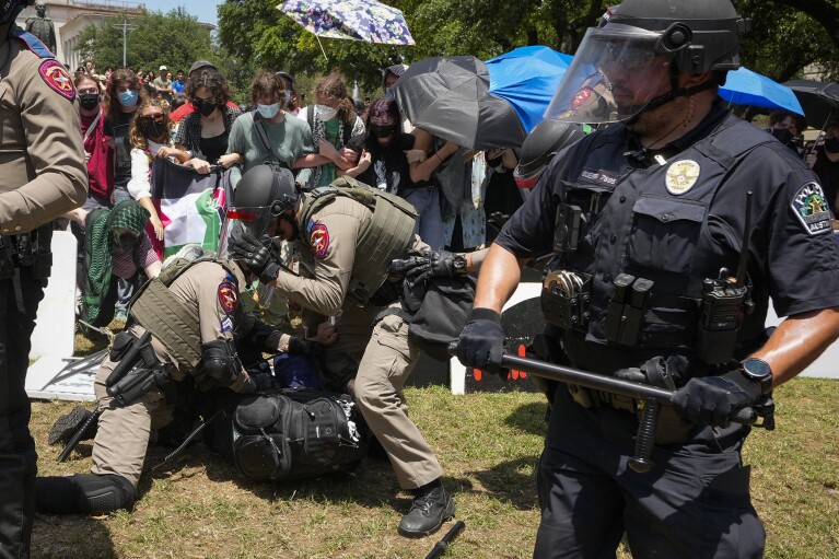 State troopers arrest a pro-Palestinian protester at the University of Texas in Austin, Texas, Monday, April 29, 2024. (Jay Janner/Austin American-Statesman via AP)