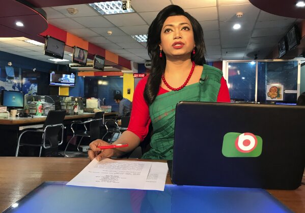 Bangladesh's first transgender news anchor Tashnuva Anan Shishir reads news bulletin , in Dhaka, Bangladesh, Tuesday, March 9, 2021. A Bangladeshi satellite television station has signed up the South Asian county's first transgender news anchor with a hope to remove the deeply-rooted social stigma they face. Shishir, who previously worked as a rights activist and an actor, appeared before audience on Monday after her appointment recently as the day coincided with the International Women's Day. She made the debut by reading a three-minute daily news bulletin on Dhaka-based Boishakhi TV. (AP Photo/Al-emrun Garjon)