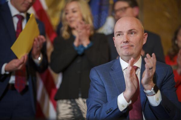 Gov. Spencer Cox applauds after signing two social media regulation bills during a ceremony at the Capitol building in Salt Lake City on Thursday, March 23, 2023. Cox signed a pair of measures that aim to limit when and where children can use social media and stop companies from luring kids to the sites. (Trent Nelson/The Salt Lake Tribune via AP)