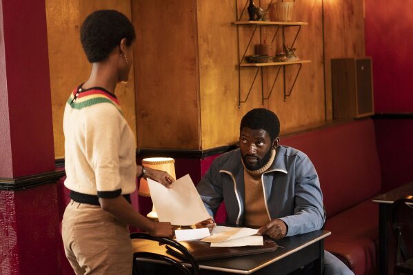 This image released by Amazon Prime Video shows Letitia Wright as Altheia Jones-LeCointe, left, and Malachi Kirby as Darcus Howe in a scene from "Mangrove." (Des Willie/Amazon Prime Video via AP)