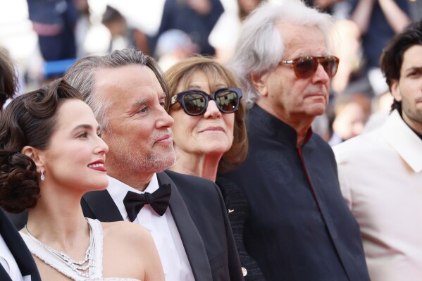 Zoey Deutch, from left, director Richard Linklater, Michele Halberstadt and producer Laurent Petin pose for photographers upon arrival at the premiere of the film 'Nouvelle Vague' at the 78th international film festival, Cannes, southern France, Saturday, May 17, 2025. (Photo by Joel C Ryan/Invision/AP)