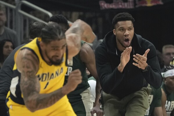 Milwaukee Bucks' Giannis Antetokounmpo reacts from the bench during the first half of Game 1 of the NBA playoff basketball game Sunday, April 21, 2024, in Milwaukee. (AP Photo/Morry Gash)