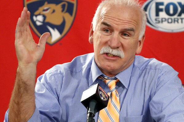 FILE - Florida Panthers head coach and former Chicago Blackhawks coach Joel Quenneville responds to a question during his first visit back to Chicago as a head coach before an NHL hockey game between the Blackhawks and the Panthers, Jan. 21, 2020. The NHL has reinstated executives Stan Bowman and Al MacIsaac and coach Quenneville. They are able to seek employment around the league effective immediately. Bowman, MacIsaac and Quenneville were banned from the league in October 2021 for their roles in the Blackhawks' mishandling of a video coach sexually assaulting a player in 2010. (ĢӰԺ Photo/Charles Rex Arbogast, File)