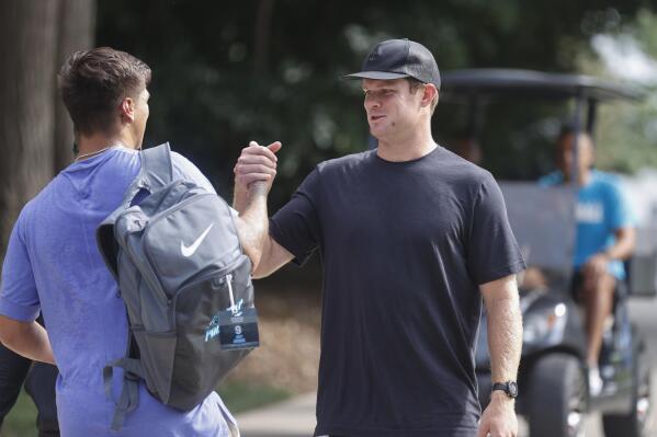 Carolina Panthers quarterbacks Matt Corral, left, and Sam Darnold greet each other at the NFL football team's training camp at Wofford College in Spartanburg, S.C., Tuesday, July 26, 2022. (AP Photo/Nell Redmond)