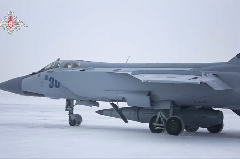 FILE - This image taken from video released by the Russian Defense Ministry Press Service on Feb. 19, 2022, shows a MiG-31K fighter of the Russian air force carrying a Kinzhal hypersonic cruise missile parked at an air field during a military drills. (Russian Defense Ministry Press Service via AP, File)
