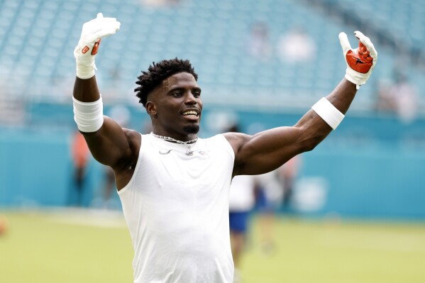 Miami Dolphins wide receiver Tyreek Hill warms before a preseason NFL football game against the Washington Commanders, Saturday, Aug. 17, 2024, in Miami Gardens, Fla. (AP Photo/Rhona Wise)