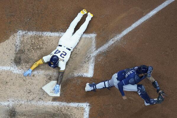 St. Louis, United States. 19th Aug, 2021. Milwaukee Brewers Kolten Wong  smiles as he lays at home plate after sliding safely in the fourth inning  against the St. Louis Cardinals at Busch