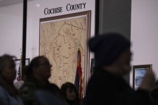 FILE - Members of the public attend a Cochise County, Ariz., Board of Supervisors meeting to provide feedback on the proposed transfer of election functions and duties to the county recorder, Feb. 14, 2023, in Bisbee, Ariz. Bob Bartelsmeyer, the elections director of a rural Arizona county who pushed false claims that voter fraud was behind President Donald Trump's 2020 election loss is resigning five months after being hired. Bartelsmeyer submitted his resignation last Friday, Sept. 15, 2023. (AP Photo/Alberto Mariani, File)