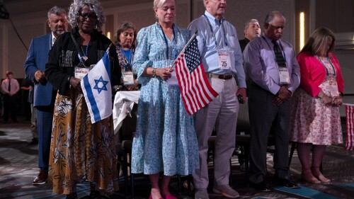 Holding U.S. and Israeli flags, a crowd of largely Evangelical Christians pray during the Christians United For Israel (CUFI) 