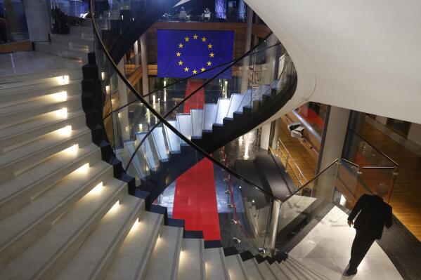 FILE - A man walks down stairs during a special session on lobbying Monday, Dec. 12, 2022 at the European Parliament in Strasbourg, eastern France. The major center-left political group embroiled in a corruption scandal at the European Parliament will seek this week to insulate itself from more fallout in the cash-for-influence affair linked to Qatar and Morocco as Belgian justice authorities target its members. (AP Photo/Jean-Francois Badias, File)