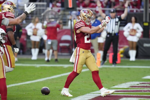 San Francisco 49ers running back Christian McCaffrey celebrates after scoring against the Arizona Cardinals during the second half of an NFL football game Sunday, Dec. 17, 2023, in Glendale, Ariz. (AP Photo/Ross D. Franklin)