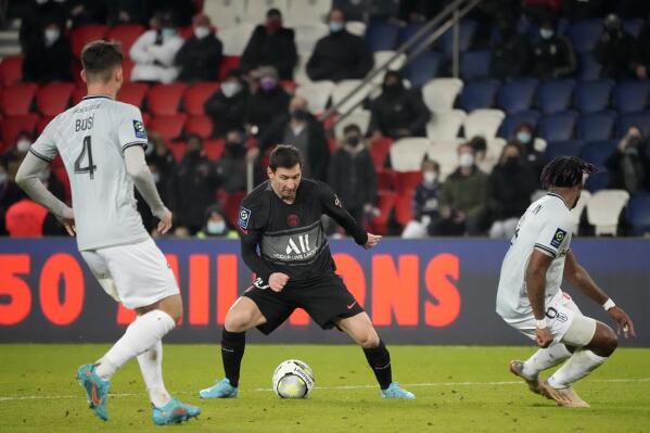 PSG's Lionel Messi, center, controls the ball during the French League One soccer match between Paris Saint Germain and Reims at the Parc des Princes in Paris, Sunday, Jan. 23, 2022. (AP Photo/Francois Mori)