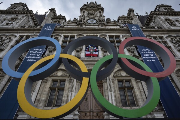 FILE - The Olympic rings in front of the Paris City Hall, in Paris, Sunday, April 30, 2023. Some Russian athletes will be allowed to compete at the 2024 Paris Olympics, the IOC said Friday, Dec. 8, 2023 in a decision that removed the option of a blanket ban over the invasion of Ukraine. (AP Photo/Aurelien Morissard, File)