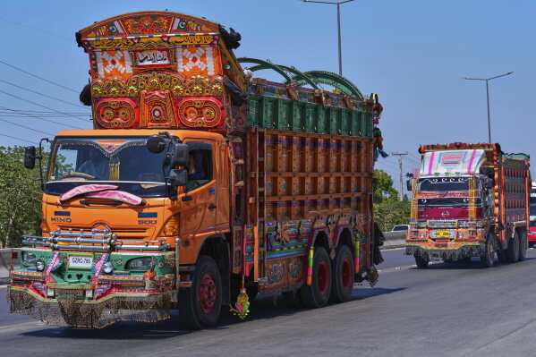 Trucks decorated with artwork drive along a highway on the outskirts of Islamabad, Pakistan, on Sunday, April 27, 2025. (AP Photo/Anjum Naveed)