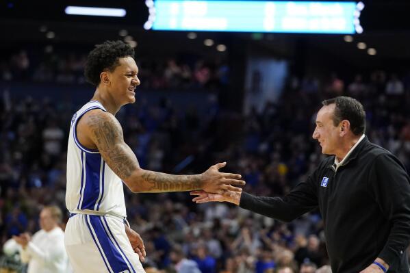 Duke's Paolo Banchero (5) greets head coach Mike Krzyzewski after a win against Michigan State following a college basketball game in the second round of the NCAA tournament, Sunday, March 20, 2022, in Greenville, S.C. (AP Photo/Brynn Anderson)
