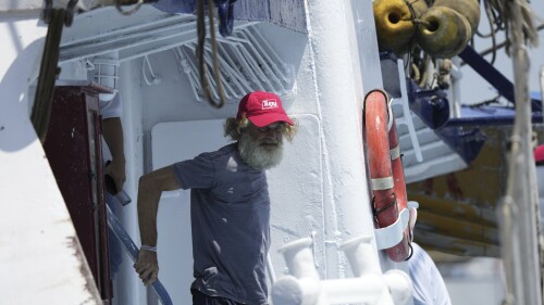 Australian Timothy Lyndsay Shaddock gets off the tuna boat "Maria Delia" that rescued him and his dog Bella, as he arrives to port in Manzanillo, Mexico, Tuesday, July 18, 2023. After being adrift with his dog for three months, the pair were rescued by the Mexican boat from his incapacitated catamaran in the Pacific Ocean some 1,200 miles from land. (AP Photo/Fernando Llano)
