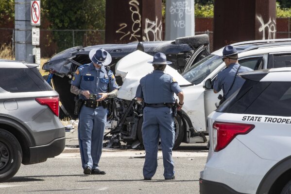 First responders investigate a crash that left six dead and others injured Sunday, July 16, 2023, in Tacoma, Wash. No one will face criminal charges following a two-car crash in Tacoma, Washington, that killed six Arizona residents in July, according to Pierce County prosecutors, Friday, Oct. 20, 2023. (Luke Johnson/The Seattle Times via AP)