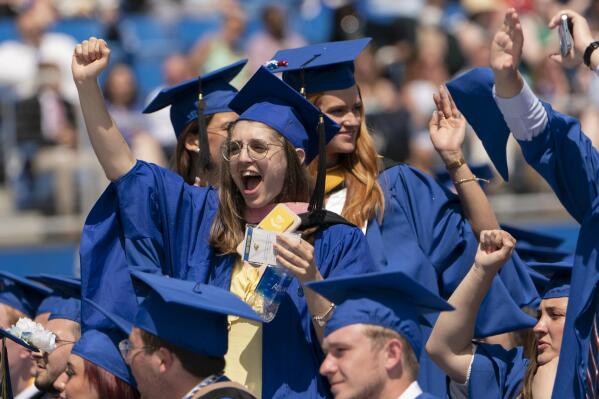 FILE - Graduates celebrate during the University of Delaware Class of 2022 commencement ceremony in Newark, Del., Saturday, May 28, 2022. The Department of Education says borrowers who hold eligible federal student loans and have made voluntary payments since March 13, 2020, can get a refund.(AP Photo/Manuel Balce Ceneta)