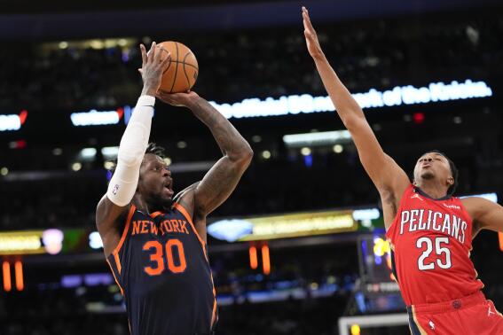New York Knicks forward Julius Randle (30) shoots a 3-point basket past New Orleans Pelicans guard Trey Murphy III (25) during the first half of an NBA basketball game Saturday, Feb. 25, 2023, at Madison Square Garden in New York. (AP Photo/Mary Altaffer)