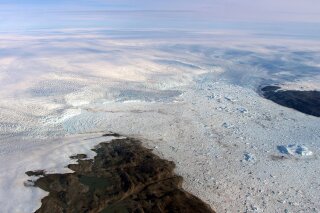 
              This 2016 photo provided by NASA shows patches of bare land at the Jakobshavn glacier in Greenland. The major Greenland glacier that was one of the fastest shrinking ice and snow masses on Earth is growing again, a new NASA study finds. The Jakobshavn glacier around 2012 was retreating about 1.8 miles (3 kilometers) and thinning nearly 130 feet (almost 40 meters) annually. But the last two years it started growing again at about the same rate, according to a study released on Monday, March 25, 2019, in Nature Geoscience. Study authors and outside scientists think this is temporary.  (NASA via AP)
            