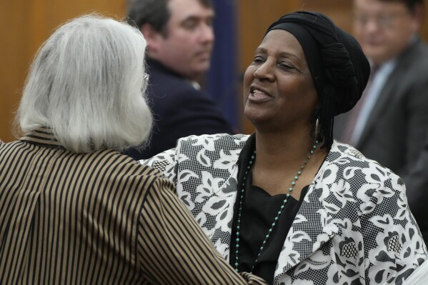 FILE - Sabreen Sharrief, right, reaches out to hug fellow plaintiff Dorothy Triplett after testifying at a hearing May 10, 2023, in Hinds County Chancery Court in Jackson, Miss., where a judge heard arguments about a Mississippi law that would allow some circuit judges to be appointed rather than elected. The Mississippi Supreme Court issued a ruling Thursday, Sept. 21, 2023, striking down the part of the law dealing with four appointed circuit judges for Hinds County. (AP Photo/Rogelio V. Solis, File)