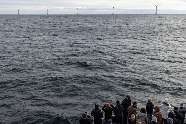 FILE - Guests observe turbines at Block Island Wind Farm, an offshore wind farm, Dec. 7, 2023, off the coast of Block Island, R.I. According to a new report published Tuesday, April 16, 2024, last year, marked the best year for new wind projects. (AP Photo/Julia Nikhinson, File)
